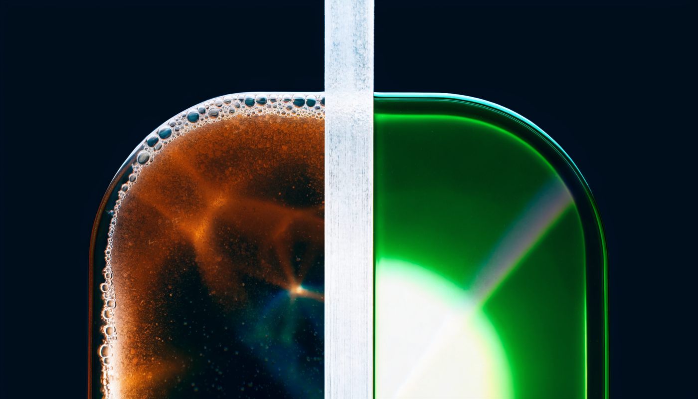 Illustration contrasting two states of oil either side of a glass divider: clouded, particle-laden fluid on the left, clear green fluid on the right.